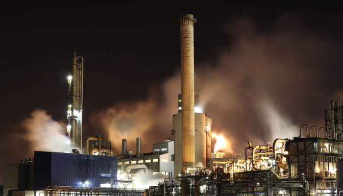 brown-and-white-factory-building-during-night-time-3855962